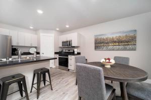 a kitchen and dining room with a table and chairs at Delightful, new townhome downtown in Billings