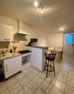 a kitchen with a sink and a stove top oven at Gîte du Messager 6/8 personnes in La Machine