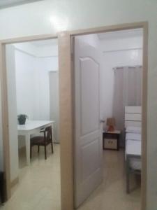 een deur naar een kamer met een tafel en een bureau bij Kendall Place Apartment in Cagayan de Oro