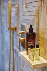 a bottle of soap on a shelf next to a wall at One Suite in San Marino