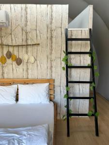 a bedroom with a ladder next to a bed at EvergreenGlamping in Kumluca