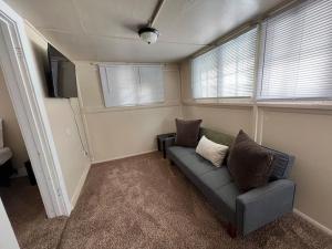 a living room with a couch and a tv at Classic home on a quiet street in Billings