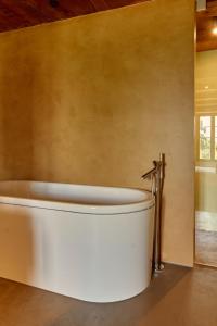 a bath tub in a bathroom with a wall at Château Salavaux in Salavaux