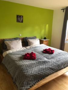 a bedroom with a bed with red roses on it at Zur Mühle in Varel