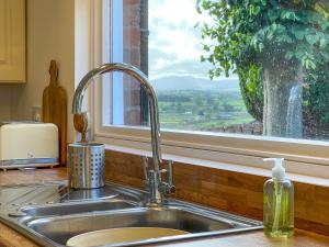 a kitchen sink with a window with a view at Fell View - Dog-Friendly House, Enclosed Garden & Great Views in Penrith