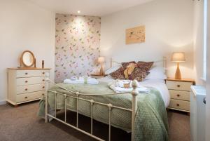 a bedroom with a bed and two night stands at Fell View - Dog-Friendly House, Enclosed Garden & Great Views in Penrith