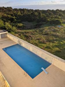an empty swimming pool on the roof of a house at Duplex by the Beach in Ovar