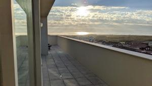 a balcony with a view of the ocean at Duplex by the Beach in Ovar