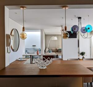 a kitchen and dining room with a wooden table at Duplex by the Beach in Ovar