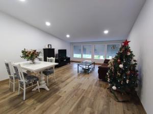 a living room with a christmas tree and a table at Casa Jardin Vigo in Vigo