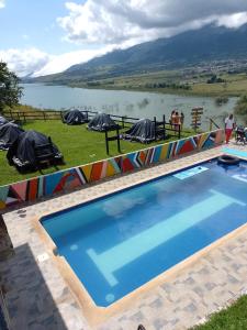 a swimming pool with a view of a lake at Faera Hostel in Darién