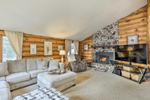 a living room with a couch and a fireplace at Lake Nokomis Escape with Dock and Beach Access in Tomahawk