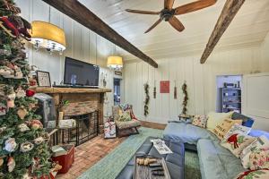 a living room with a christmas tree and a couch at Historic Marshall Log Cabin Less Than 1 Mi to Dtwn! in Marshall