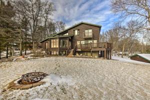 a house in the snow with a yard at Lake Nokomis Escape with Dock and Beach Access in Tomahawk