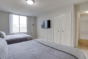 a bedroom with two beds and a flat screen tv at Amazing 2 Bedroom Condo At Arlington With Gym in Arlington