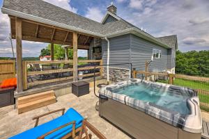 a hot tub on the patio of a house at Chic Williamstown Retreat with Pool and Hot Tub! in Williamstown
