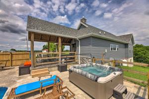 a house with a hot tub on a patio at Chic Williamstown Retreat with Pool and Hot Tub! in Williamstown