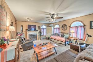 a living room with a couch and a table at Spacious Michigan Home with Private Hot Tub in Gladstone