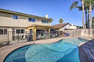 a swimming pool in front of a house at Breeze By the Pool Retreat with Game Room! in Chula Vista