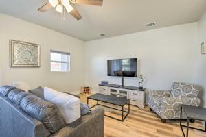 a living room with a couch and a flat screen tv at Fort Worth Retreat with Balcony Walk to TCU! in Fort Worth