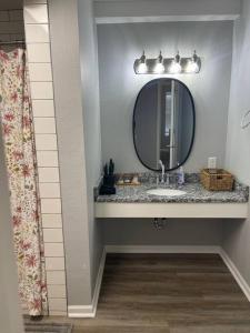 a bathroom with a sink and a mirror at The Bernice - 2 Bedroom Apt in Quilt Town, USA in Hamilton