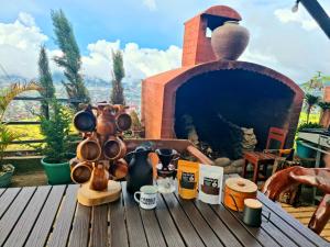 a table with pots and pans on top of a fireplace at Wanay's Rocky Mountain Homestay in Baguio