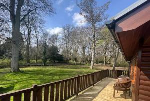 a porch of a house with a wooden fence at Jenny's Place Stunning 2 bedroom lodge in Sewerby