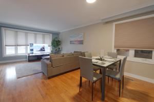 a living room with a table and a couch at Master Accord With Bath & Steps to Subway in Toronto