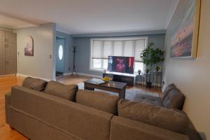 a living room with a couch and a table at Master Accord With Bath & Steps to Subway in Toronto