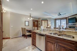 a kitchen with a sink and a dining room at True Ski-in Ski-out Luxury Condo on Peak 7 condo in Breckenridge