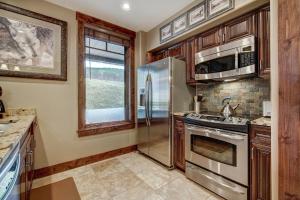 a kitchen with stainless steel appliances and a window at True Ski-in Ski-out Luxury Condo on Peak 7 condo in Breckenridge