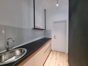 a kitchen with a sink and a door to a hallway at Nivalis Hill N&V in Jahorina +70 photos