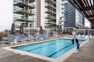 a swimming pool with lounge chairs and a building at Kasa 2nd Street Austin in Austin