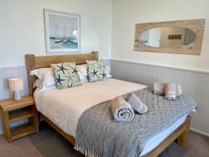 a bedroom with a bed with a mirror on the wall at Sunnybeach Holiday Apartments in Paignton