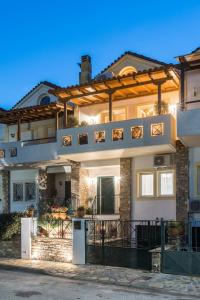 a large house with a fence in front of it at Volos luxury maisonette-Pelion view in Volos