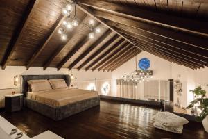a bedroom with a bed and a wooden ceiling at Volos luxury maisonette-Pelion view in Volos