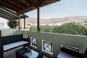 a balcony with a couch and a table at Volos luxury maisonette-Pelion view in Volos