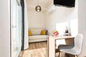 a living room with a table and a couch at Hotel Adeje Plaza in Adeje