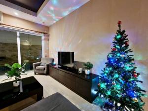 a living room with a christmas tree in a living room at Tinker Bell Pool Villa in Jomtien Beach