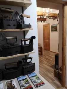 a room with wooden floors and shelves with black tool boxes at Amanda's apartment in Kuldīga