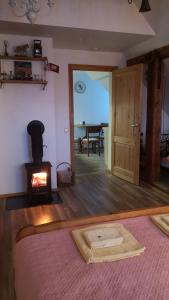a room with a fireplace and a bed and a stove at Amanda's apartment in Kuldīga +2 photos