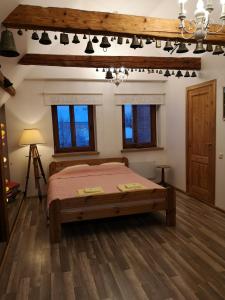 a bedroom with a bed and a wooden floor at Amanda's apartment in Kuldīga