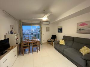 a living room with a couch and a table at Villa Hortensia - Primera linea playa la concha in Oropesa del Mar