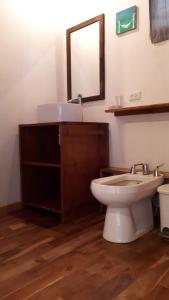 a bathroom with a sink and a toilet and a mirror at Casa SILURI UP in Santa Teresa Beach +30 photos
