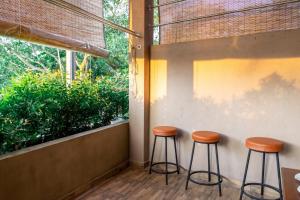 a couple of stools sitting next to a wall at Cinnamon Tan Boutique Hotel in Negombo