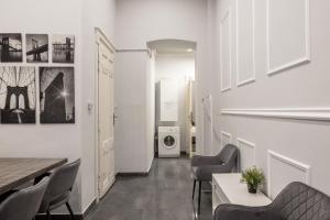 a living room with a table and chairs and a washing machine at Prime Time Vaci Budapest in Budapest