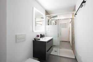 a bathroom with a sink and a mirror at Casa Hola Mar in Los Realejos +24 photos