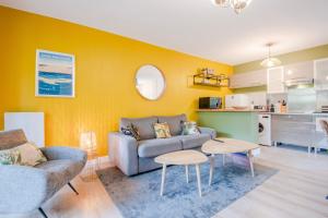 a living room with a couch and a table at Résidence du Haurat in Gujan-Mestras