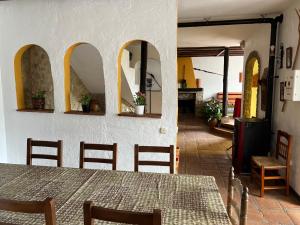 a dining room with a table and some chairs at Casa Jara in Jimera de Líbar