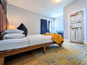 a bedroom with a wooden bed with pillows at HostWise Stays - Industrial Vintage Style, Minutes to Downtown in Pittsburgh